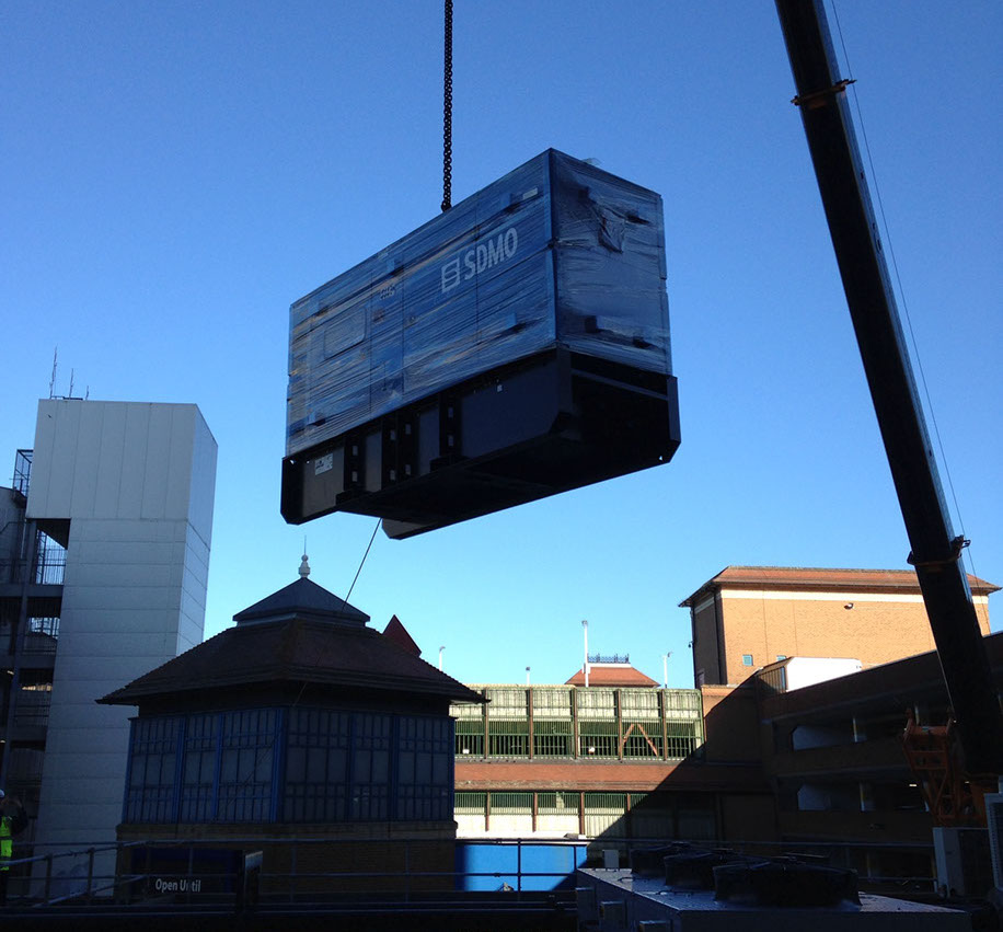 A generator being crained onto a building top and installed for a local council by Enhanced Power Services Ltd